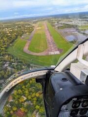 aerial view of the airfield captured through a bell 206 jet ranger helicopter