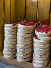Generic Espadrilles, traditional Mediterranean summer footwear, stacked on wooden shelves. Image taken from public street.