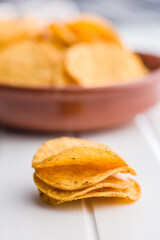 Crispy potato chips on white table.