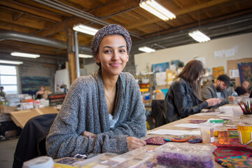 Midmorning in a workshop space with art supplies scattered about. Participants create crafts inspired by their cultural backgrounds