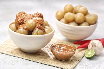 Cilok with spicy peanut sauce, a snack with a chewy and savory texture, with a spicy taste that burns the tongue
