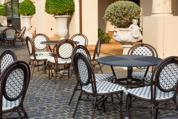 Classic white steel chair and table in the garden,empty white vintage chairs in the garden,decoration english garden concept.