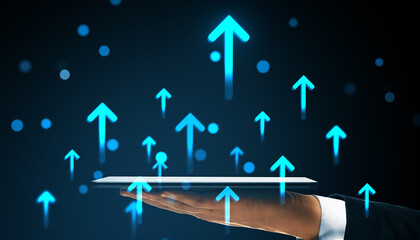 Hand holding tablet with glowing upward arrows symbolizing business growth, success, and digital progress on dark futuristic background.