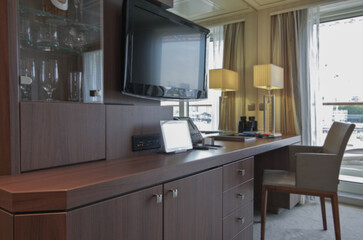 Luxurious suite stateroom cabin room onboard luxury yacht cruise ship cruiseship liner with bedroom and living area in purple and creme with wood in modern Art Deco interior design