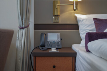 Luxurious suite stateroom cabin room onboard luxury yacht cruise ship cruiseship liner with bedroom and living area in purple and creme with wood in modern Art Deco interior design