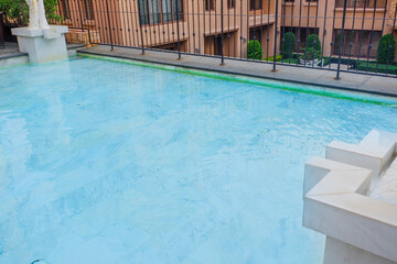 Empty swimming pool with sunbed and white umbrella in resort hotel for vacation leisure and white sand,resort neary sea and beach in summer.