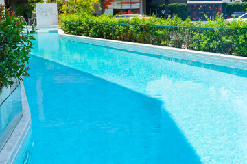 Empty swimming pool with table and chairs in summer,sofa resort neary sea and beach,restaurant and lunch,rest vacation concept.
