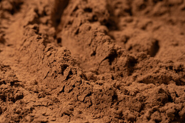 Cocoa powder pile close-up, rotation. Pastry chef. Brown cocoa powder texture circle rotation close-up. Chocolate	
