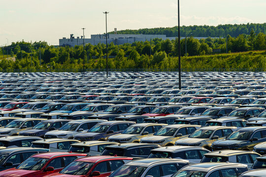 Russia, Kaluga, AGR Automotive Group - July 7, 2025: A wide aerial shot shows an enormous parking lot filled with brand new cars outside an automobile factory. Chery and Tenet chineese auto.