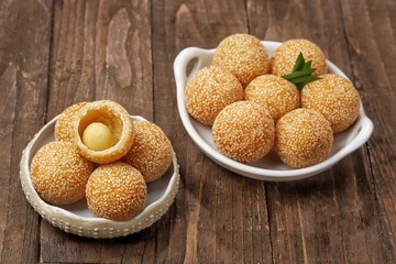 Onde-onde or Kuih Bom or Banh Cam or Jian Dui is a traditional snack made from sticky rice flour with a skin coated with sesame seeds and filled with mungbean