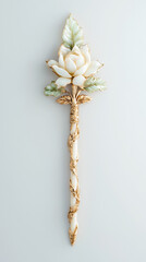 Elegant floral hairpin with white flower and green leaves, wrapped in gold details, showcasing delicate craftsmanship and vintage style