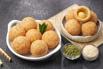 Onde-onde or Kuih Bom or Banh Cam or Jian Dui is a traditional snack made from sticky rice flour with a skin coated with sesame seeds and filled with mungbean