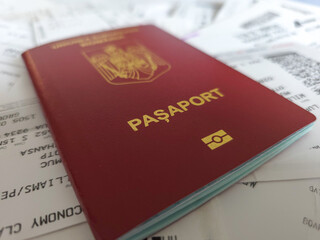 Romanian European Union biometric passport with boarding pass against a white background  