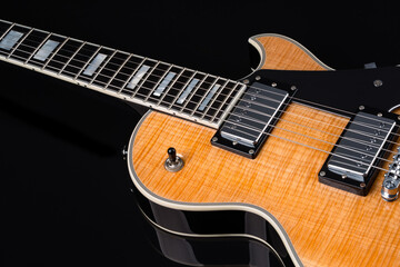 Fototapeta premium Electric guitar with natural pattern isolated on black background.