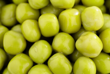 Fresh green peas background, texture of perfect peeled sweet pea grains as background. Vegetable background, vegetable protein, healthy products. Canned peas. spinning in a circle