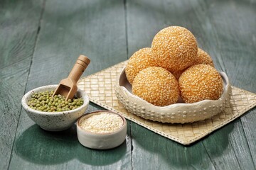 Onde-onde or Kuih Bom or Banh Cam or Jian Dui is a traditional snack made from sticky rice flour with a skin coated with sesame seeds and filled with mungbean