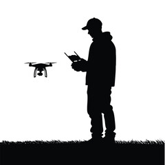 Silhouette depicts a man wearing a cap and operating a drone with a remote controller in an outdoor setting with grass