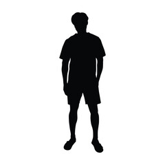 Silhouette of a man standing with his hands casually in his pockets, wearing a t-shirt and shorts.