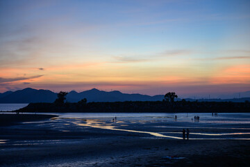 The scenery of the tidal flats by the sea at dusk