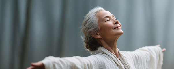 Serene woman with arms outstretched, eyes closed, basking in sunlight. Represents freedom, mindfulness, joy, and wellness. Ideal for health, lifestyle content.