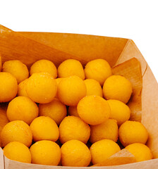 Delicious yellow sweets in a paper box at a local market