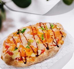 Freshly baked flatbread topped with colorful ingredients and balsamic drizzle