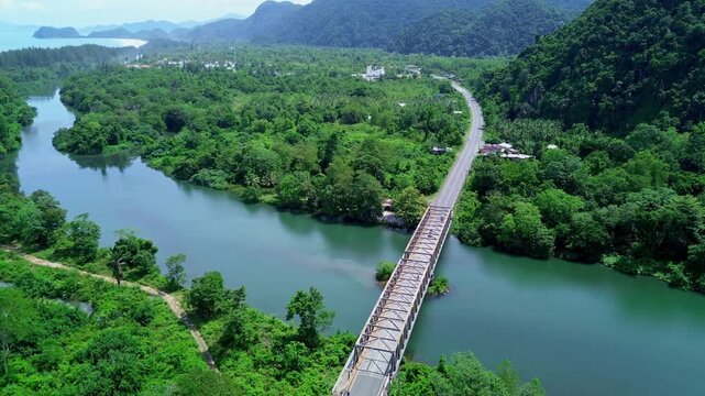 Drone View of a Scenic Bridge and Road Through the Tropical Landscape of Aceh, Indonesia