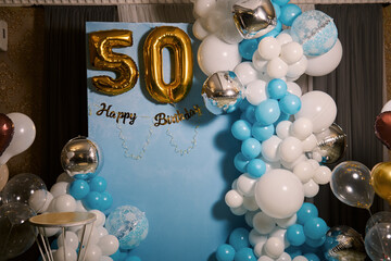 Photo zone decoration in blue tones during the 50th anniversary celebration