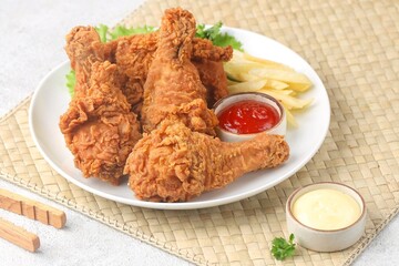 Crispy fried chicken is a dish made from pieces of chicken that have been coated with flour or a thin batter that is seasoned and fried, deep-fried, fried in a pressure fryer, or air-fried.