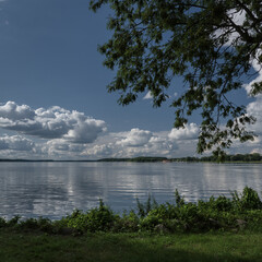 SUMMERTIME - Beautiful lake landscape with cumulus clouds against a blue sky