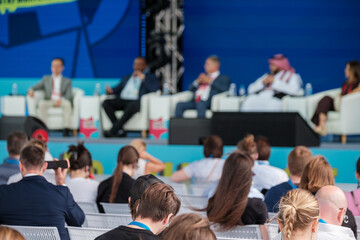 Obraz premium Audience attending panel discussion with professionals sharing insights and ideas during a conference event