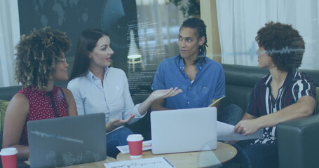 Team of four professionals in business attire sitting and discussing in office lounge, with laptops