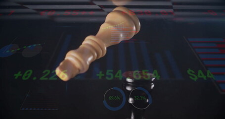 Falling light chess king above dark chess king on trading desk, with stock charts and gauges