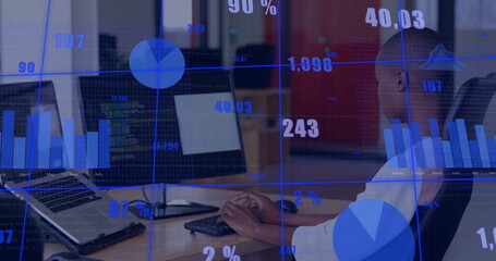 Typing African American man in white shirt using keyboard and monitors at open office, copy space