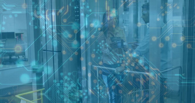 Gesturing IT pros inspecting open server racks at data center, with tablet and Ethernet cables
