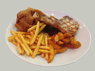 Crispy German Pork Knuckle with pork chop steak and fries.