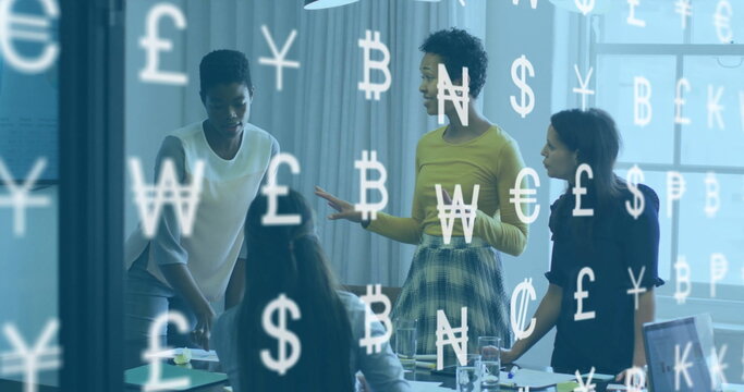 Discussing currency trends, businesswomen gesturing around table in meeting room, with laptop - Powered by Adobe