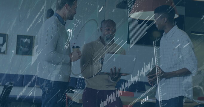 African American man in pullover explaining data on laptop at office with smartphone and coffee cup - Powered by Adobe