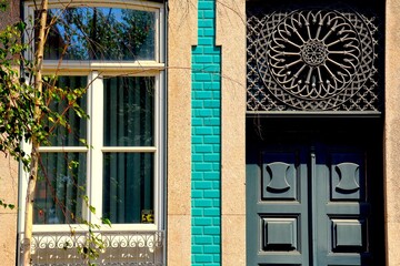 Facade of historical house in Porto, Portugal, with signature historical doors of Porto buildings.