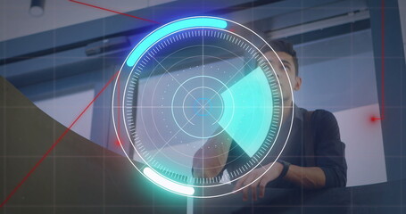 Reaching forward technician operating console in control room, using holographic radar interface