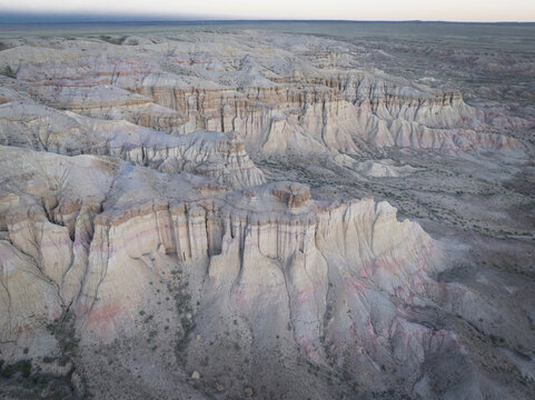 Aerial view of the majestic Tsagaan Suvarga formations, sculpted by time and nature's hand, revealing soft pinks and creams against a vast Mongolian sky., Tsagaan Suvarga, Dundgovi, Mongolia.
