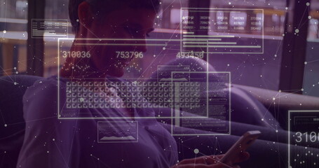 Working woman wearing eyeglasses holding smartphone on sofa in home lounge, with digital overlays