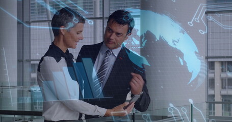 Colleagues in business attire examining smartphone data overlay near glass railing in office