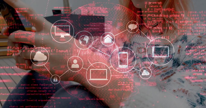 Pairing developers analyzing network icon on code overlay at wooden desk, with laptop smartphone