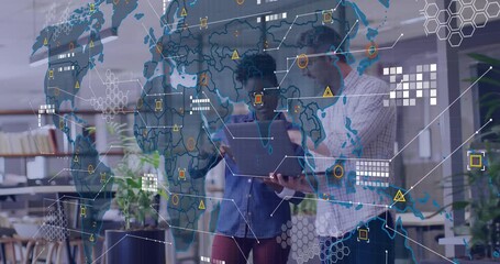 Colleagues holding laptop and entering business data activating 3D world map with warning icons - Powered by Adobe