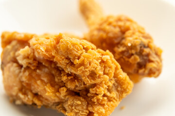 crispy fried chicken on white plate close up