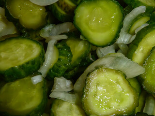 Freshly sliced pickled cucumbers with onions close-up
