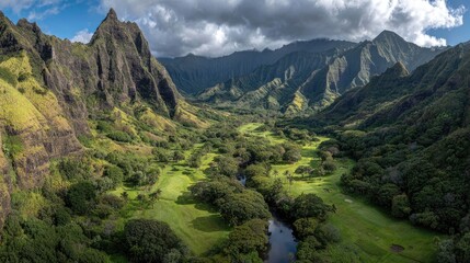 Fototapeta premium Lush valley, golf course, dramatic mountains
