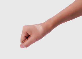 Swatch of liquid foundation on a hand, showcasing a smooth, radiant finish against a neutral background