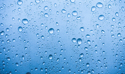 Closeup of Water Droplets on a Light Blue Surface